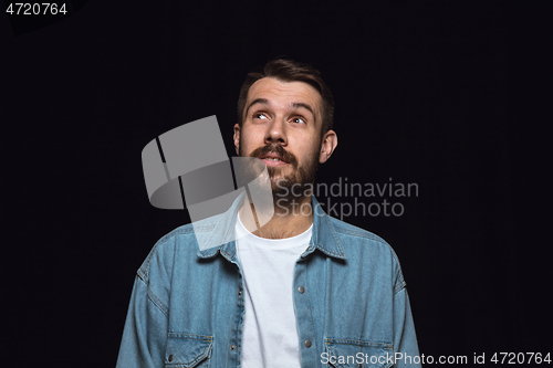 Image of Close up portrait of young man isolated on black studio background