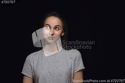 Image of Close up portrait of young woman isolated on black studio background