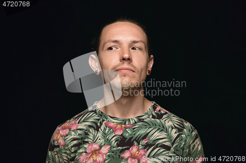 Image of Close up portrait of young man isolated on black studio background