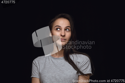 Image of Close up portrait of young woman isolated on black studio background