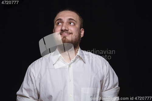 Image of Close up portrait of young man isolated on black studio background