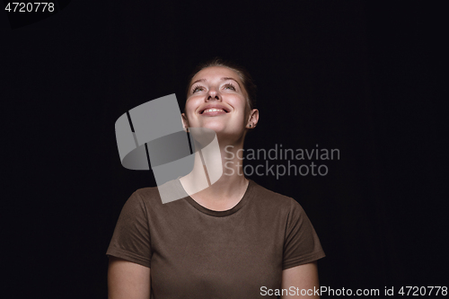 Image of Close up portrait of young woman isolated on black studio background