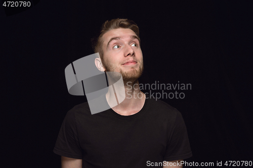 Image of Close up portrait of young man isolated on black studio background