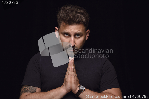 Image of Close up portrait of young man isolated on black studio background