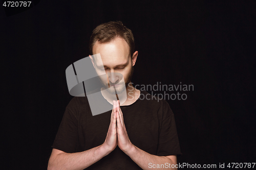 Image of Close up portrait of young man isolated on black studio background