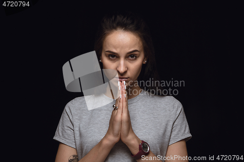 Image of Close up portrait of young woman isolated on black studio background