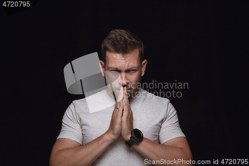 Image of Close up portrait of young man isolated on black studio background