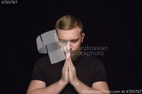 Image of Close up portrait of young man isolated on black studio background