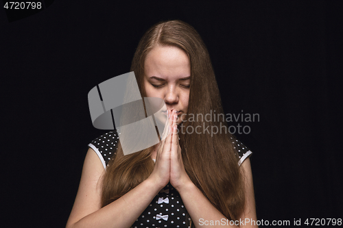 Image of Close up portrait of young woman isolated on black studio background