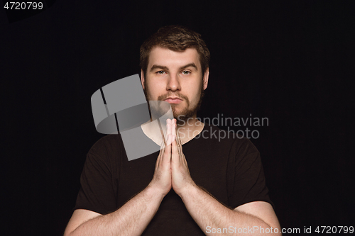 Image of Close up portrait of young man isolated on black studio background