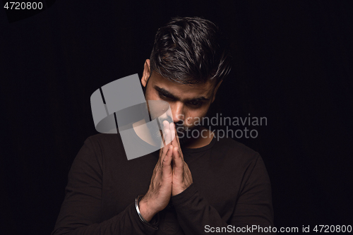 Image of Close up portrait of young man isolated on black studio background