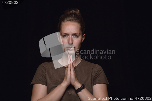 Image of Close up portrait of young woman isolated on black studio background