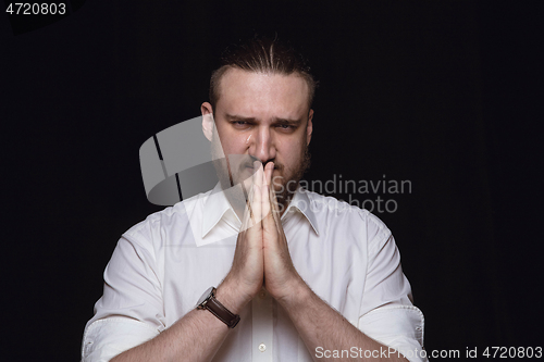 Image of Close up portrait of young man isolated on black studio background