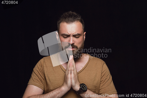 Image of Close up portrait of young man isolated on black studio background