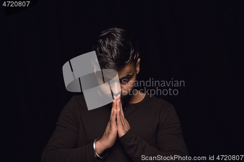 Image of Close up portrait of young man isolated on black studio background