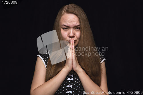 Image of Close up portrait of young woman isolated on black studio background