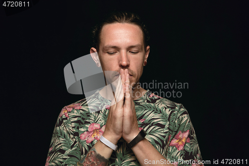 Image of Close up portrait of young man isolated on black studio background