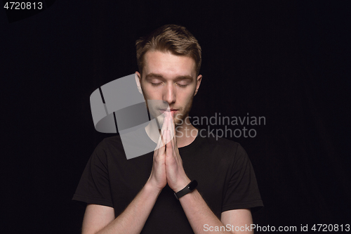 Image of Close up portrait of young man isolated on black studio background