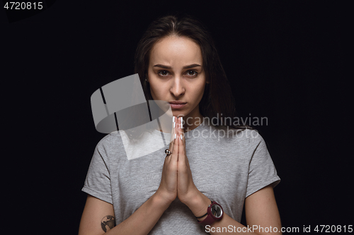 Image of Close up portrait of young woman isolated on black studio background