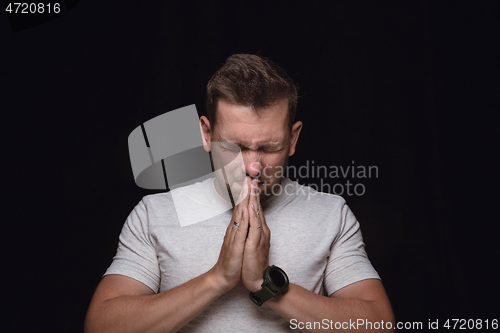 Image of Close up portrait of young man isolated on black studio background