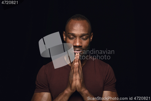 Image of Close up portrait of young man isolated on black studio background