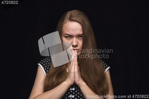 Image of Close up portrait of young woman isolated on black studio background