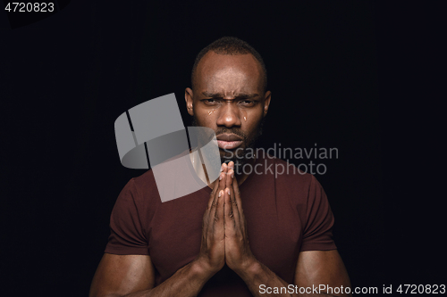 Image of Close up portrait of young man isolated on black studio background