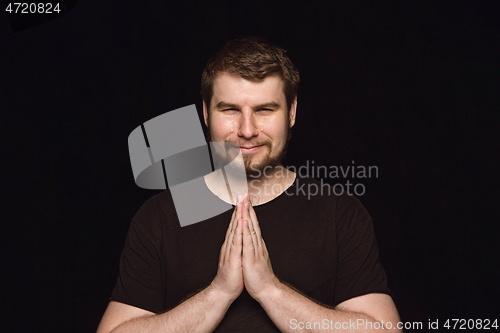 Image of Close up portrait of young man isolated on black studio background