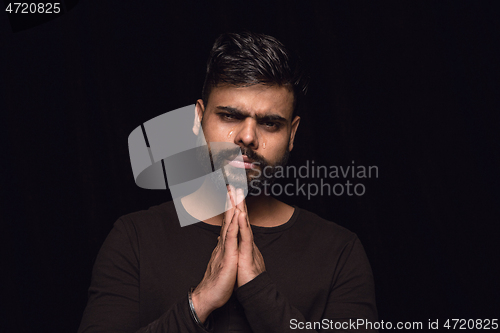 Image of Close up portrait of young man isolated on black studio background