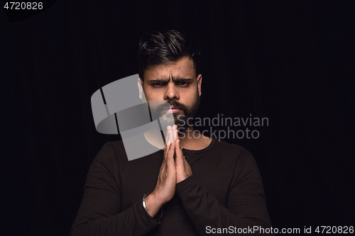 Image of Close up portrait of young man isolated on black studio background