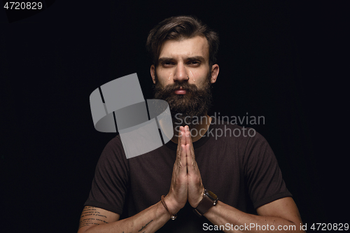 Image of Close up portrait of young man isolated on black studio background