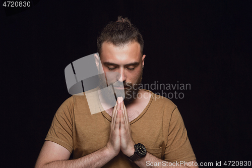 Image of Close up portrait of young man isolated on black studio background