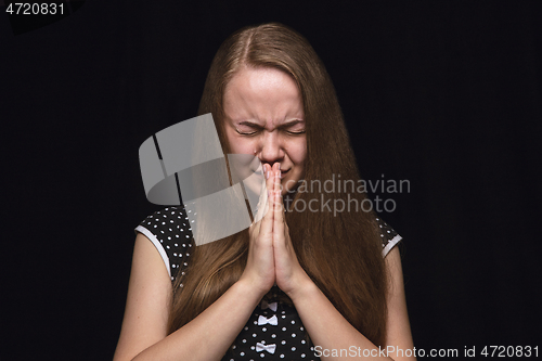 Image of Close up portrait of young woman isolated on black studio background