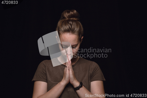 Image of Close up portrait of young woman isolated on black studio background