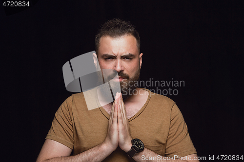 Image of Close up portrait of young man isolated on black studio background