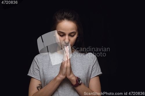 Image of Close up portrait of young woman isolated on black studio background