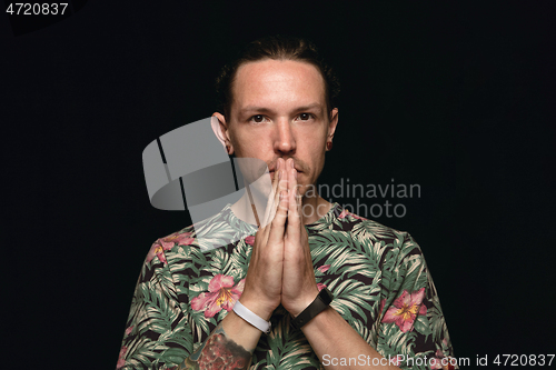 Image of Close up portrait of young man isolated on black studio background