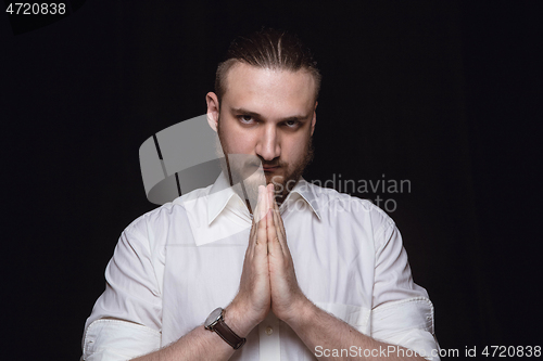 Image of Close up portrait of young man isolated on black studio background