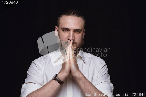 Image of Close up portrait of young man isolated on black studio background