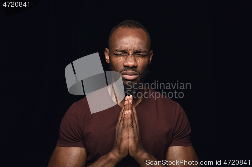 Image of Close up portrait of young man isolated on black studio background