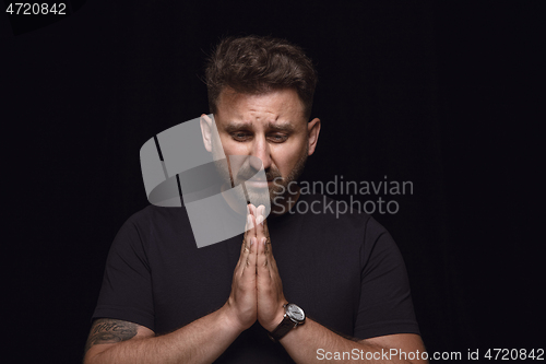 Image of Close up portrait of young man isolated on black studio background