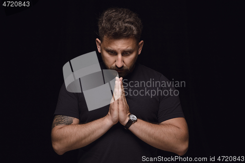 Image of Close up portrait of young man isolated on black studio background