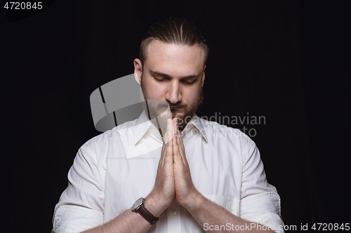 Image of Close up portrait of young man isolated on black studio background