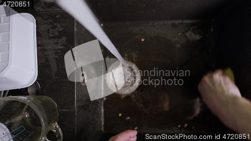 Image of Cleaning up black sink closeup footage