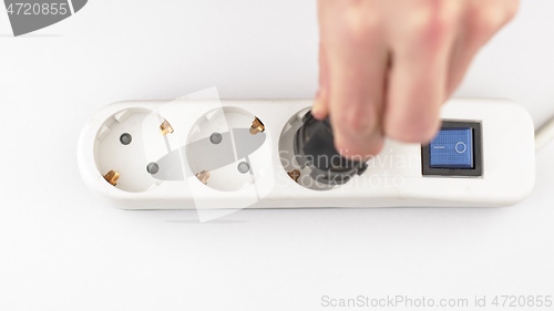 Image of Filling Electric socket holes with electric plugs closeup footage