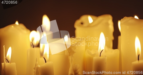 Image of Candles glowing against dark background