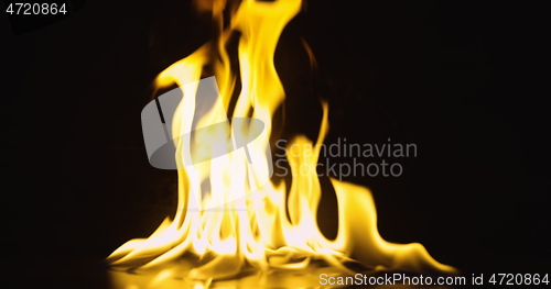 Image of Fire dancing against dark background 120fps slow motion loopable footage