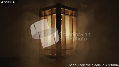 Image of Lamp made out of wood against dark background with smoke