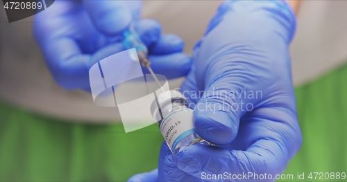 Image of Vaccine in human hands closeup footage