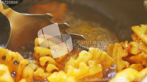 Image of French fries boiling in sunflower oil